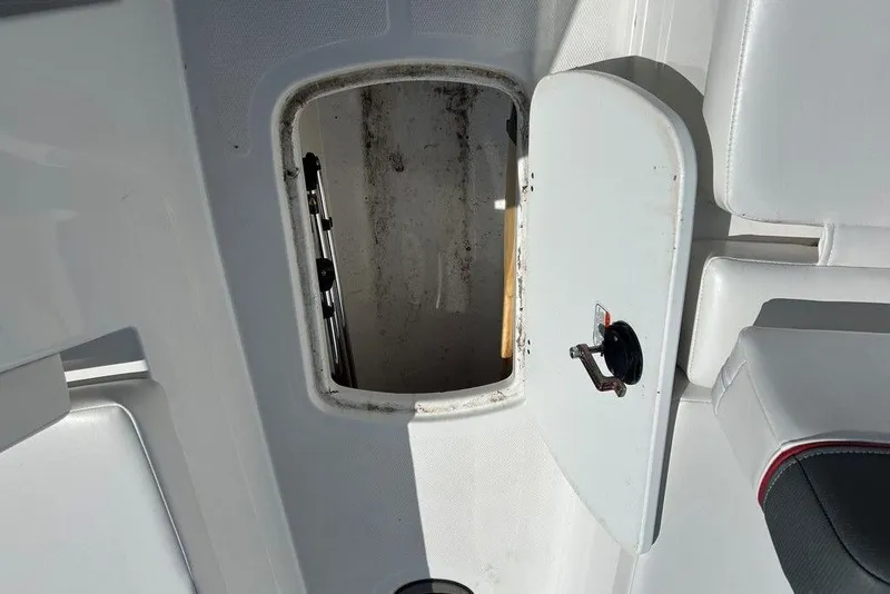 Slide: The Image of Open storage compartment on a 2025 Tahoe T18 boat, featuring white interior. - 12