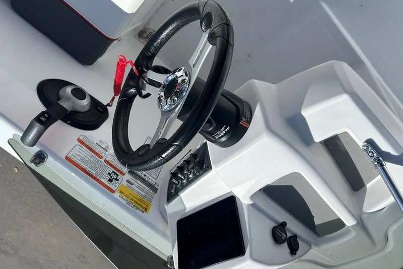 Slide: The Image of Steering console of a 2025 Tahoe T18 boat with controls and safety features. - 17