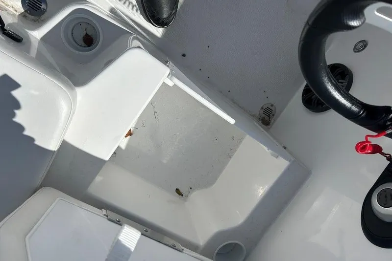 Slide: The Image of Interior view of a 2025 Tahoe T18 boat, featuring steering wheel and seating area. - 18