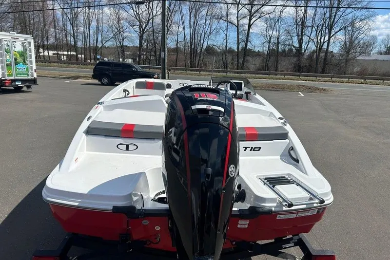 Slide: The Image of 2025 Tahoe T18 boat with Mercury engine, parked outdoors on a sunny day. - 3