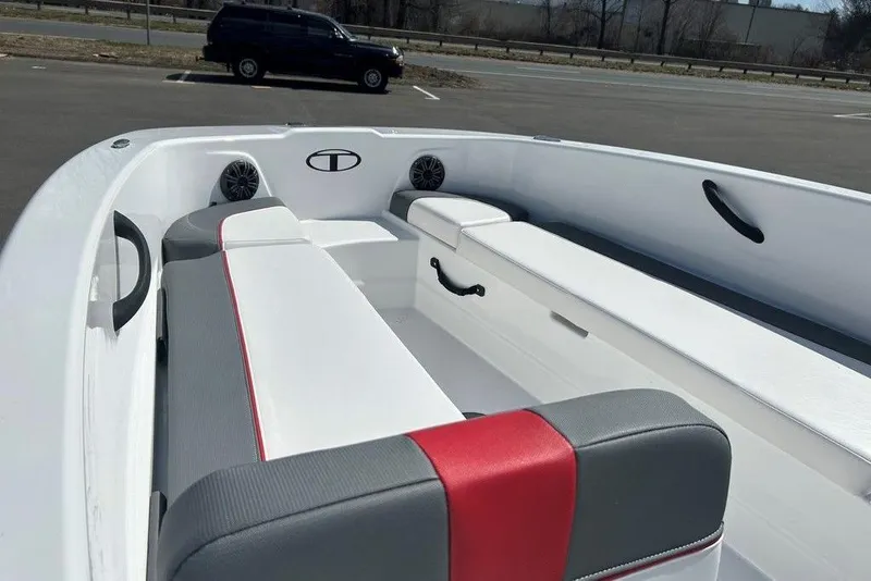 Slide: The Image of 2025 Tahoe T18 boat interior with white and gray seating, red accents, and speakers. - 6
