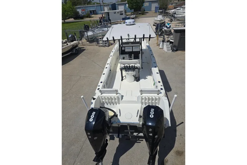Slide: The Image of 2002 Sport-Craft Seacat 255 boat with dual outboard motors, docked in a marina. - 30