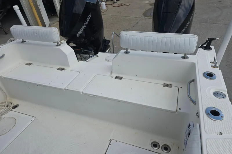 Slide: The Image of 2002 Sport-Craft Seacat 255 boat interior with Mercury engines and seating area. - 10