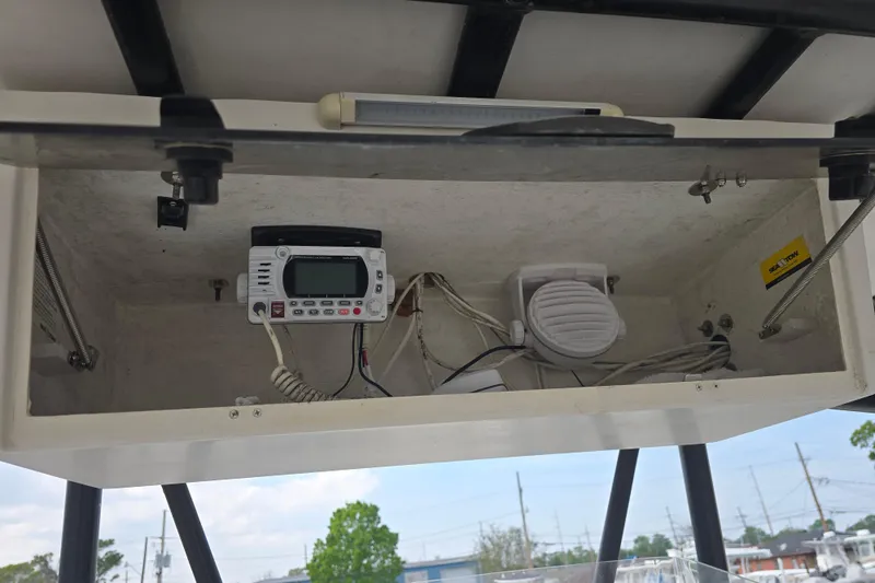 Slide: The Image of 2002 Sport-Craft Seacat 255 boat electronics compartment with radio and wiring. - 11