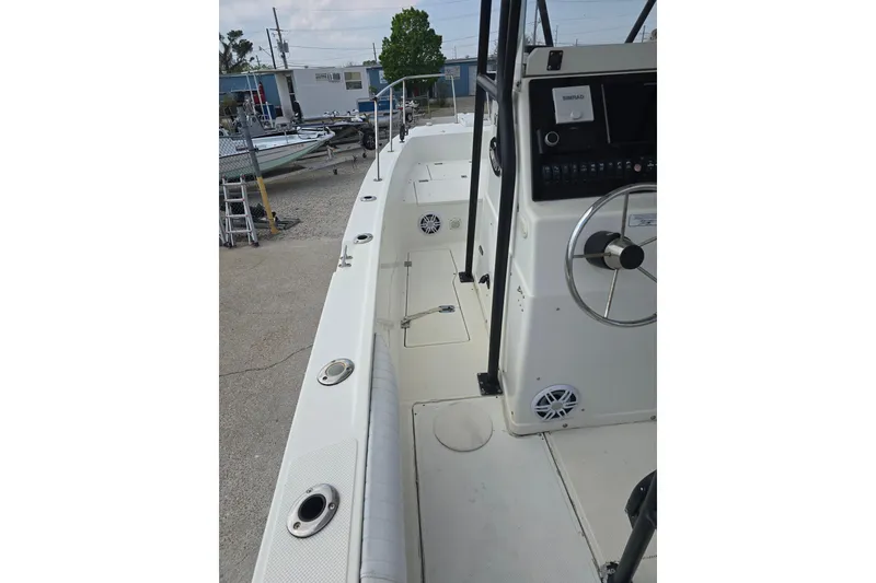 Slide: The Image of 2002 Sport-Craft Seacat 255 boat interior with steering console and seating area. - 12