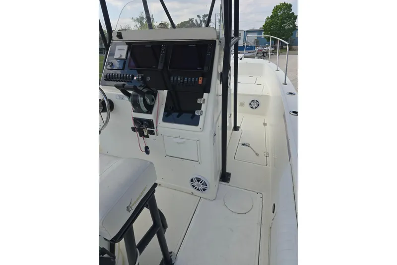 Slide: The Image of 2002 Sport-Craft Seacat 255 boat cockpit with navigation controls and seating. - 13