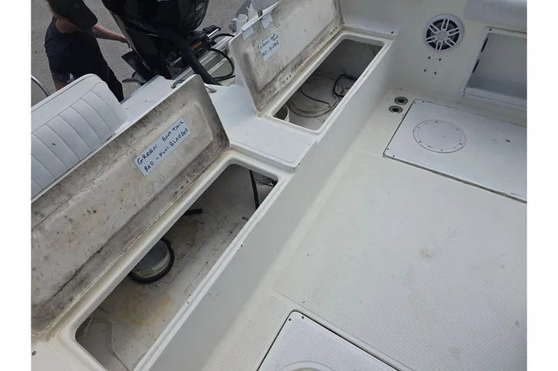 Slide: The Image of 2002 Sport-Craft Seacat 255 boat interior with open storage compartments. - 14