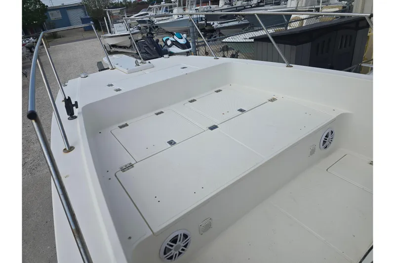 Slide: The Image of 2002 Sport-Craft Seacat 255 boat deck with storage compartments and railing. - 15