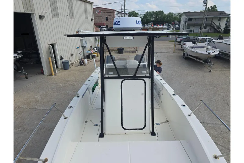 Slide: The Image of 2002 Sport-Craft Seacat 255 boat docked at a marina, featuring a central console. - 16