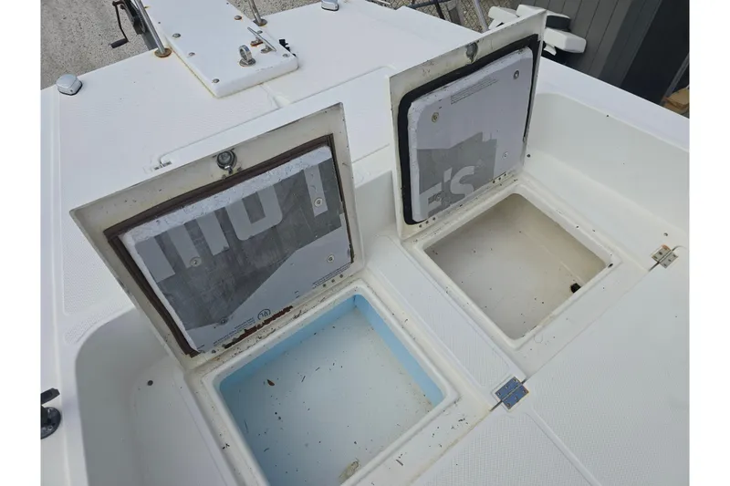Slide: The Image of Open storage compartments on a 2002 Sport-Craft Seacat 255 boat deck. - 18