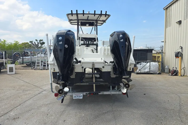 Slide: The Image of 2002 Sport-Craft Seacat 255 boat with dual outboard motors in a marina setting. - 2