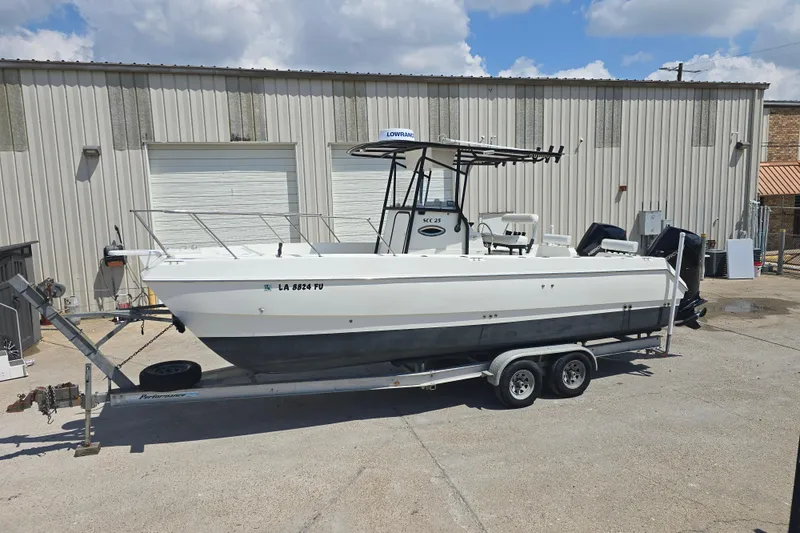 Slide: The Image of 2002 Sport-Craft Seacat 255 boat on trailer, parked outside industrial building. - 21