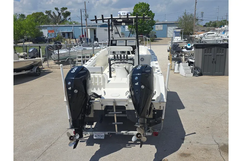 Slide: The Image of 2002 Sport-Craft Seacat 255 boat with dual outboard motors in a marina setting. - 22