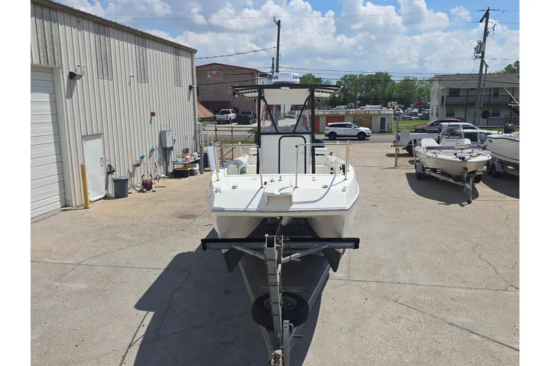 Slide: The Image of 2002 Sport-Craft Seacat 255 boat on trailer in a parking lot. - 26