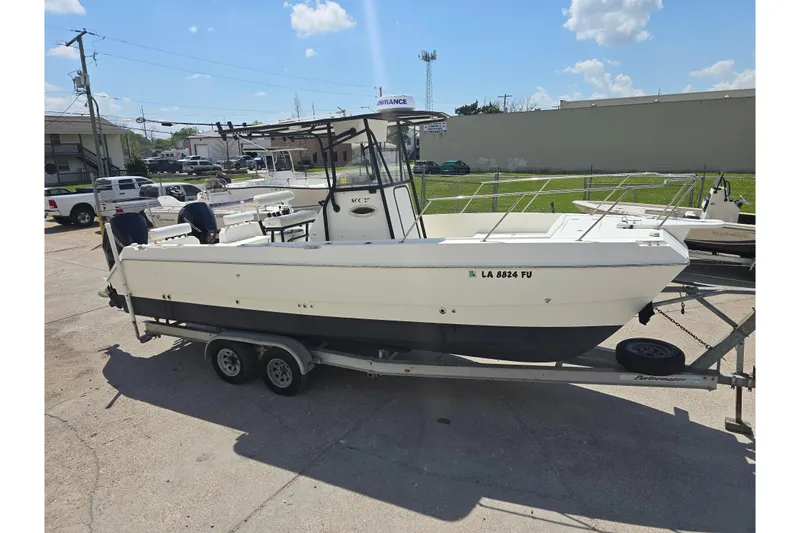 Slide: The Image of 2002 Sport-Craft Seacat 255 boat on trailer in sunny outdoor setting. - 27