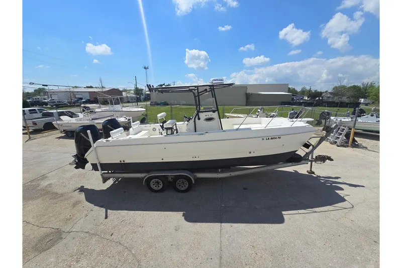 Slide: The Image of 2002 Sport-Craft Seacat 255 boat on trailer under clear blue sky. - 28