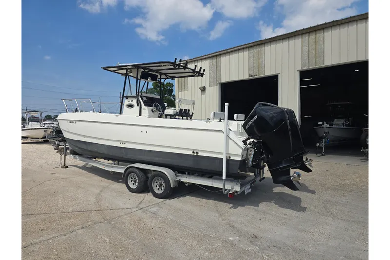 Slide: The Image of 2002 Sport-Craft Seacat 255 boat on trailer outside a warehouse. - 4
