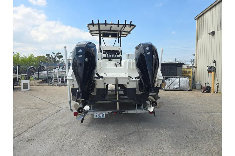 Slide: The Image of 2002 Sport-Craft Seacat 255 boat with dual outboard motors in a marina setting. - 5