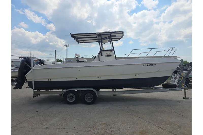 Slide: The Image of 2002 Sport-Craft Seacat 255 boat on trailer under cloudy sky. - 7