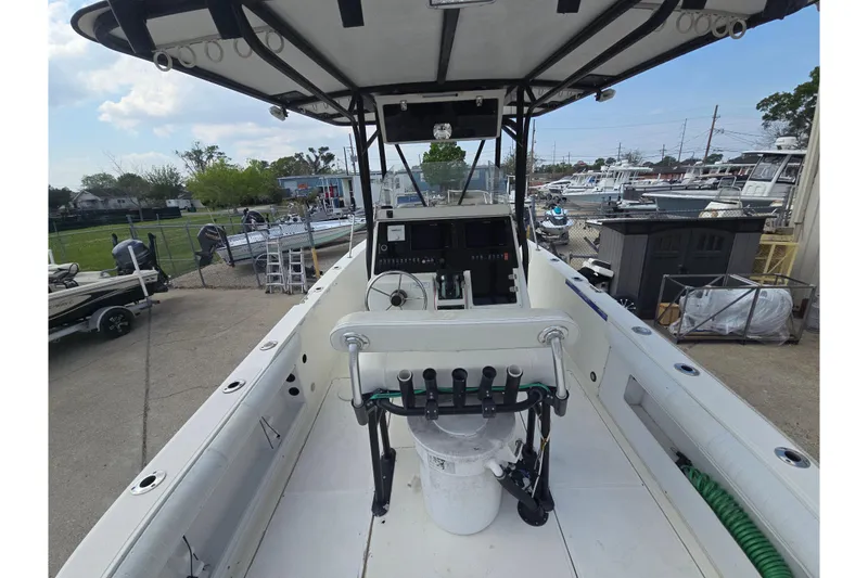 Slide: The Image of 2002 Sport-Craft Seacat 255 boat interior with steering console and fishing rod holders. - 8