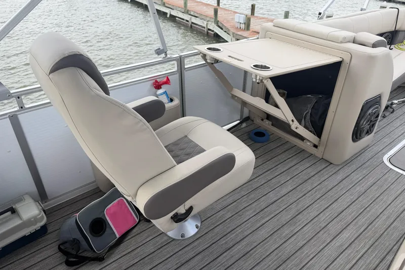 Slide: The Image of 2022 Harris FloteBote Solstice 250 interior with seating and storage features. - 12