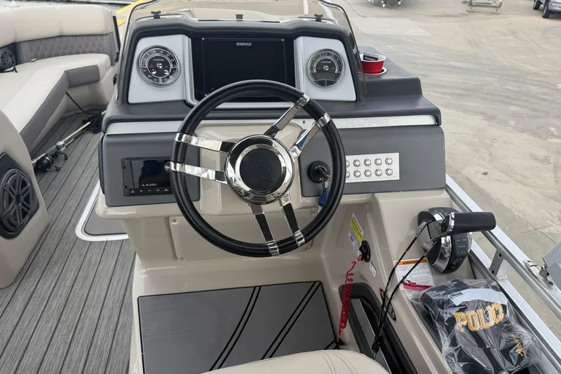 Slide: The Image of 2022 Harris FloteBote Solstice 250 boat dashboard with steering wheel and controls. - 17