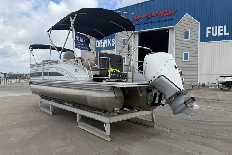Slide: The Image of 2022 Harris FloteBote Solstice 250 pontoon boat docked at MarineMax facility. - 4