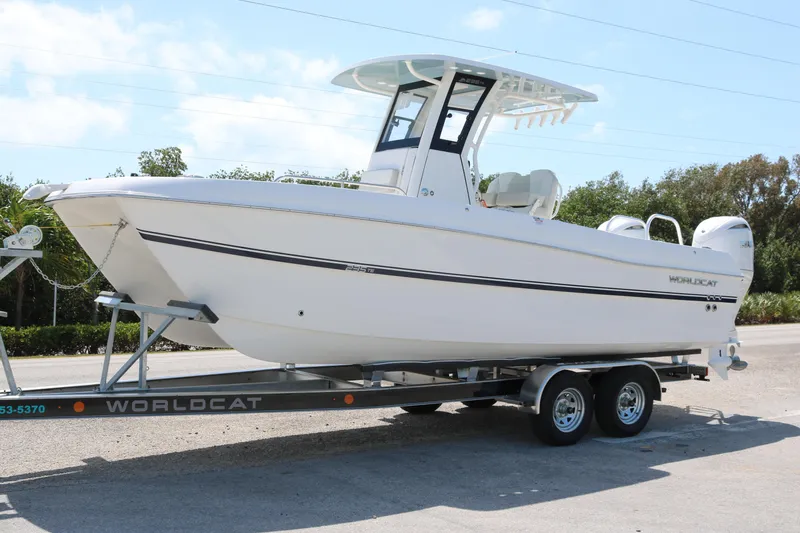 The Image of 2026 World Cat 235 TE boat on trailer, parked outdoors under clear sky. - 1