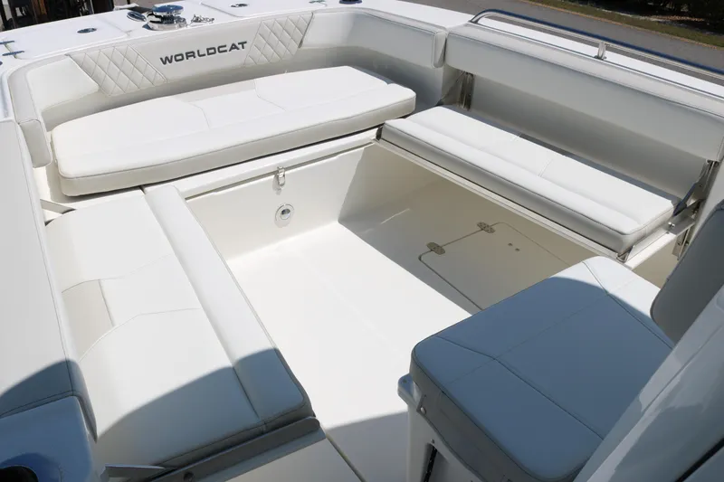 Slide: The Image of Spacious seating area on 2026 World Cat 235 TE boat, featuring white cushioned benches. - 10