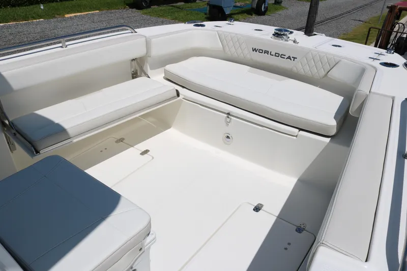 Slide: The Image of 2026 World Cat 235 TE boat interior with white cushioned seating and spacious layout. - 11
