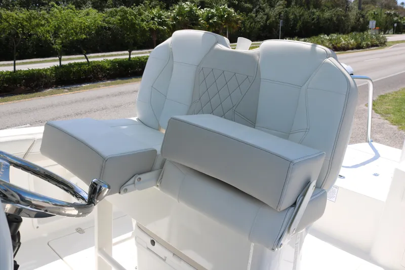 Slide: The Image of 2026 World Cat 235 TE boat with luxurious white seating and steering wheel. - 13