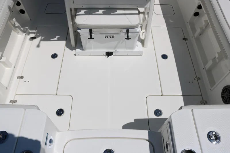 Slide: The Image of 2026 World Cat 235 TE boat deck with Yeti cooler and storage compartments. - 15