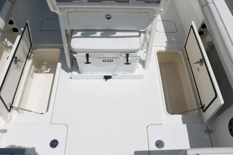 Slide: The Image of 2026 World Cat 235 TE boat interior with storage compartments and Yeti cooler. - 16