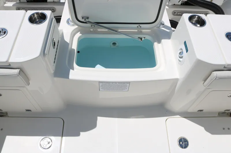 Slide: The Image of 2026 World Cat 235 TE boat with open storage compartment and cup holders. - 18