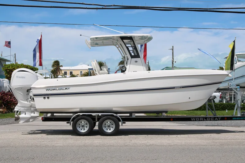 Slide: The Image of 2026 World Cat 235 TE boat on trailer, side view, outdoors. - 4