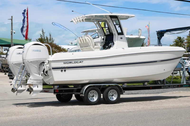 Slide: The Image of 2026 World Cat 235 TE boat on trailer with twin Yamaha engines, outdoor display. - 5
