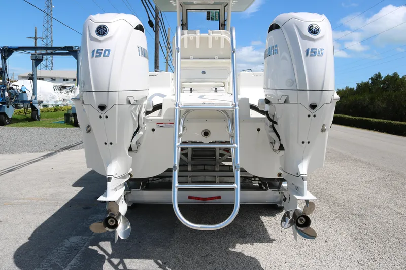 Slide: The Image of 2026 World Cat 235 TE boat with dual Yamaha 150 engines, rear view. - 6