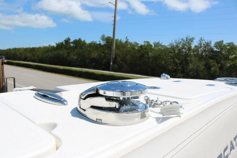 Slide: The Image of 2026 World Cat 235 TE boat deck with chrome fittings under a clear blue sky. - 7