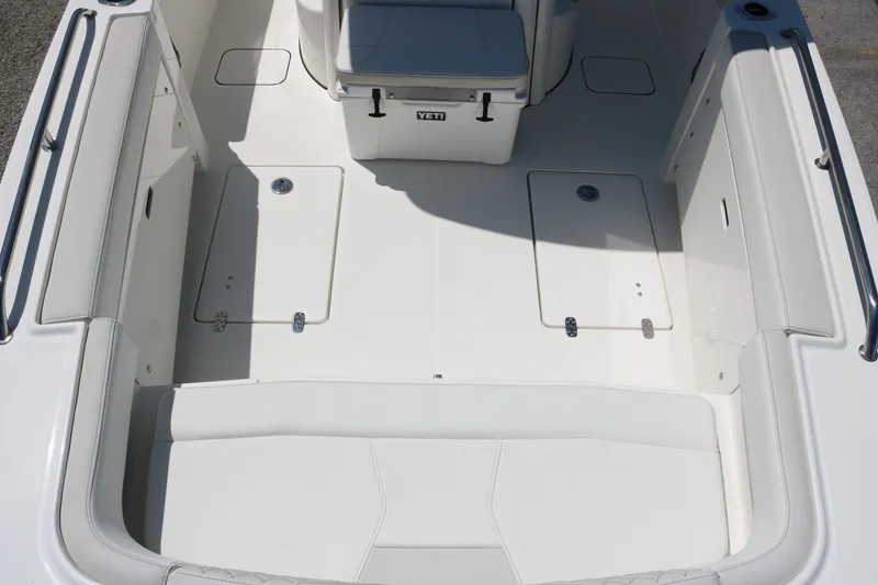 Slide: The Image of 2026 World Cat 235 TE boat interior with white seating and storage compartments. - 9