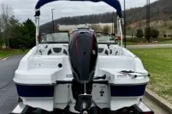 Slide: The Image of 2020 Tahoe 450 TF boat, rear view, parked outdoors on a cloudy day. - 4