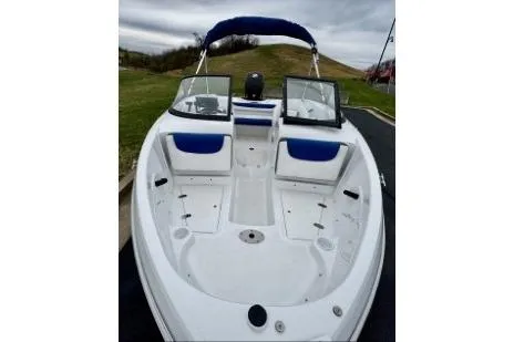 Slide: The Image of 2020 Tahoe 450 TF boat with blue accents, open bow seating, and windshield. - 9