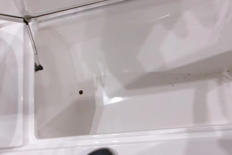 Slide: The Image of Open storage compartment of 2026 Contender 32 ST boat, showing clean interior space. - 15