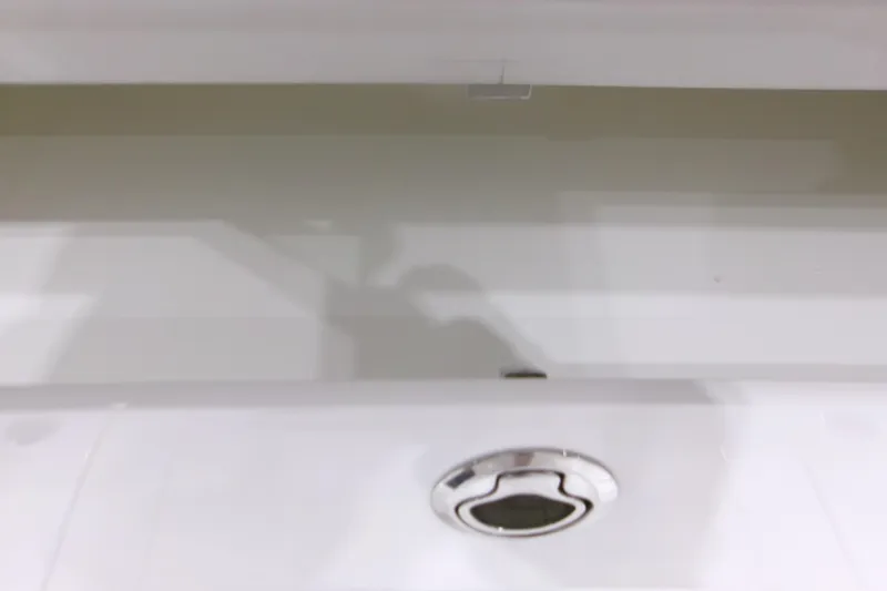 Slide: The Image of Interior view of 2026 Contender 32 ST boat compartment with latch. - 19