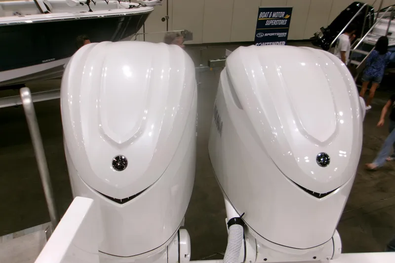 Slide: The Image of Twin Yamaha outboard engines on a 2026 Contender 32 ST boat at a showroom. - 4