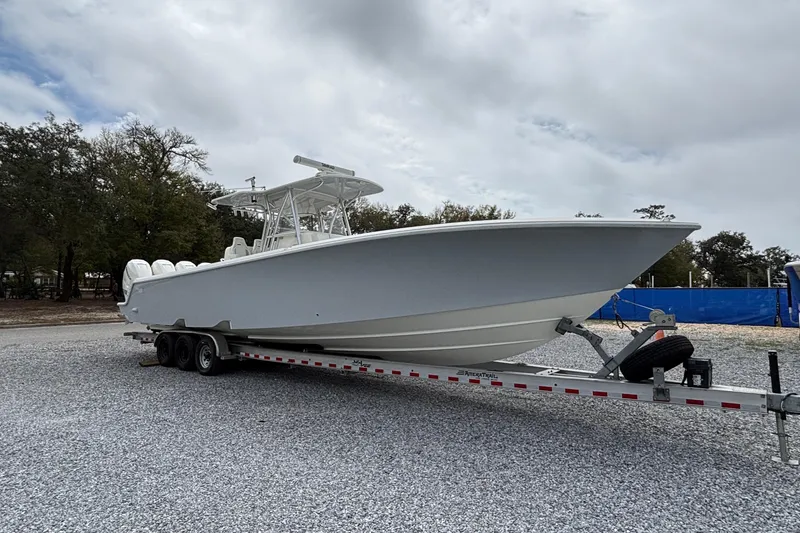 The Image of 2018 SeaVee 390Z boat on trailer, parked outdoors under cloudy sky. - 0