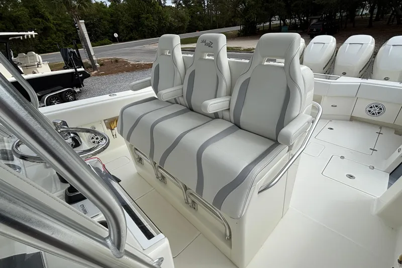 Slide: The Image of 2018 SeaVee 390Z boat interior with three cushioned seats and sleek design. - 10