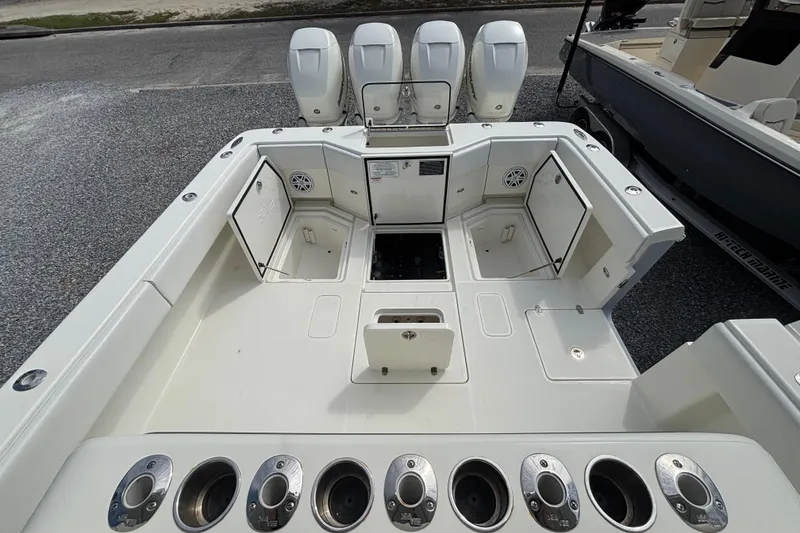Slide: The Image of 2018 SeaVee 390Z boat deck with open storage compartments and four powerful engines. - 12
