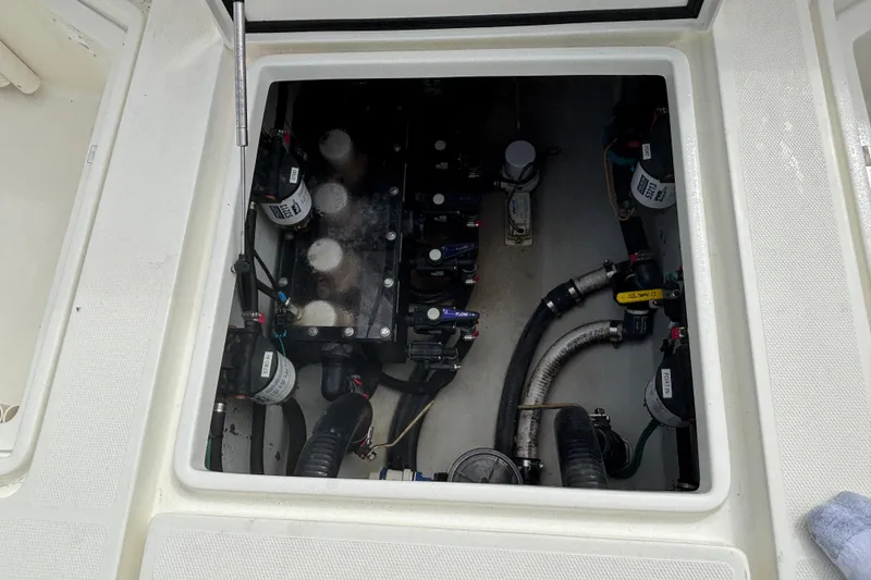 Slide: The Image of Engine compartment of a 2018 SeaVee 390Z boat, showing mechanical components and hoses. - 14