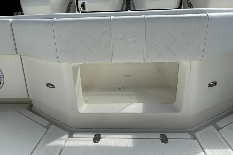 Slide: The Image of 2018 SeaVee 390Z boat storage compartment with white cushioned seating. - 17
