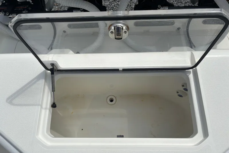 Slide: The Image of Open storage compartment on a 2018 SeaVee 390Z boat, featuring a transparent lid. - 18
